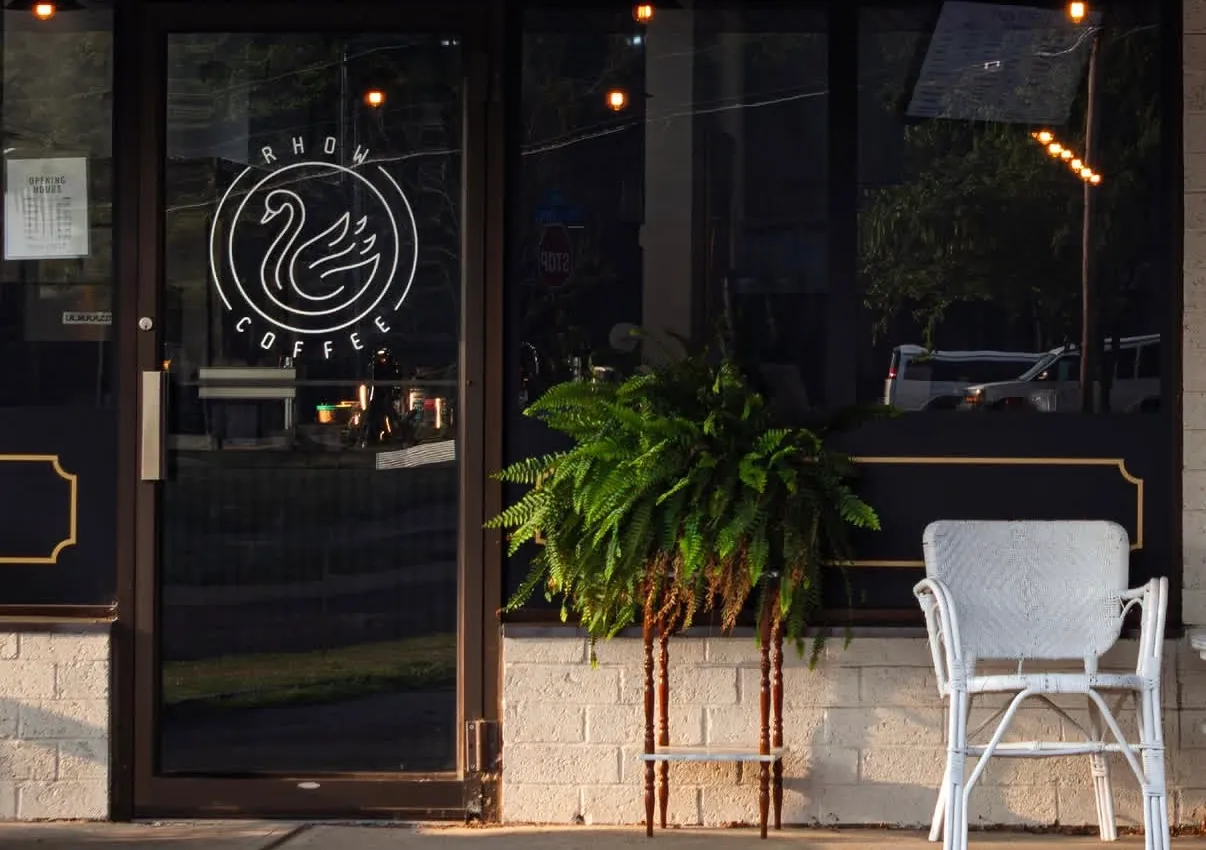 The swan badge applied to the glass of the RHOW Coffee front door